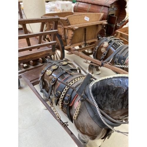 505 - Three ceramic shire horses with wooden carts together with one handmade Romany Rose gypsy caravan