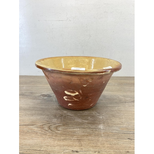 509 - A 19th century terracotta and cream glazed dairy bowl - approx. 17cm high x 32cm diameter