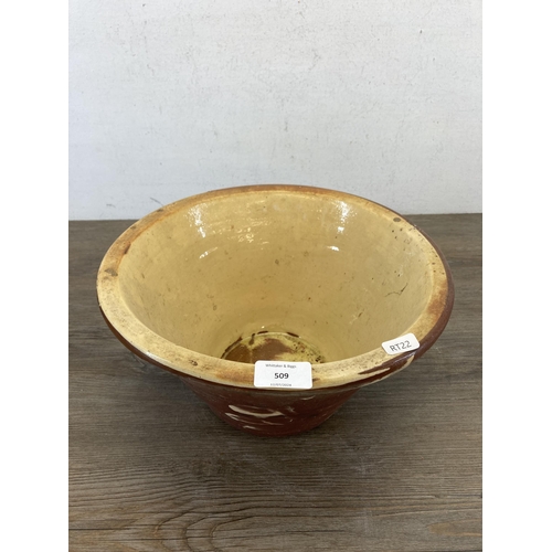 509 - A 19th century terracotta and cream glazed dairy bowl - approx. 17cm high x 32cm diameter