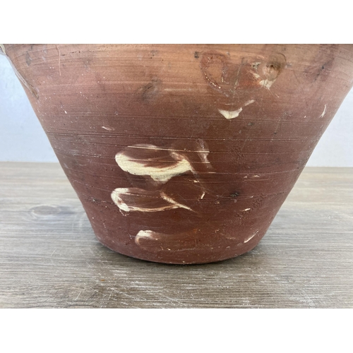 509 - A 19th century terracotta and cream glazed dairy bowl - approx. 17cm high x 32cm diameter