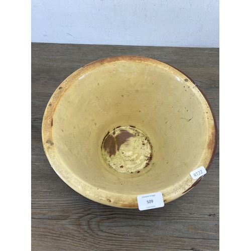 509 - A 19th century terracotta and cream glazed dairy bowl - approx. 17cm high x 32cm diameter