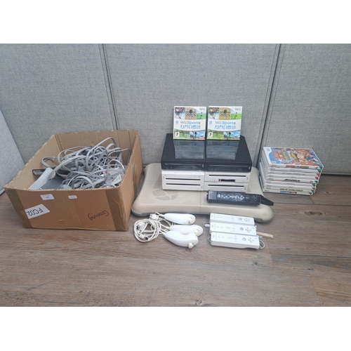 868 - Six Nintendo Wii consoles with Wii Fit board, controllers, accessories and games