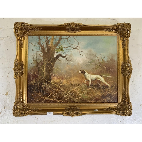 283 - A mid 20th century gilt framed oil on board of a dog hunting scene signed J. Fitz lower left - appro... 