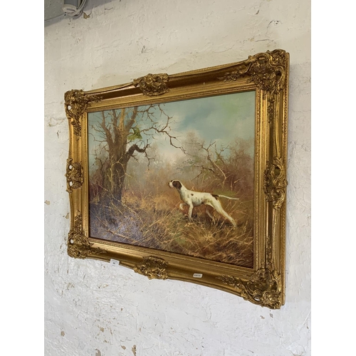 283 - A mid 20th century gilt framed oil on board of a dog hunting scene signed J. Fitz lower left - appro... 