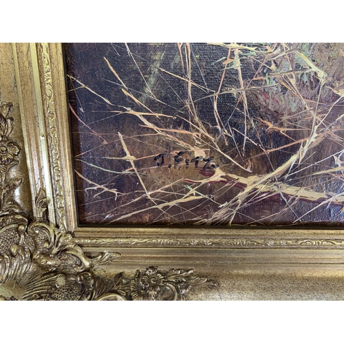 283 - A mid 20th century gilt framed oil on board of a dog hunting scene signed J. Fitz lower left - appro... 