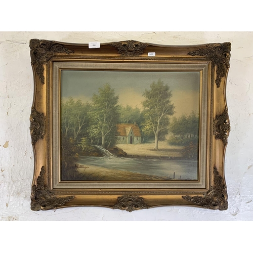 284 - A mid 20th century gilt framed oil on canvas of a riverside scene signed lower left - approx. 58cm h... 