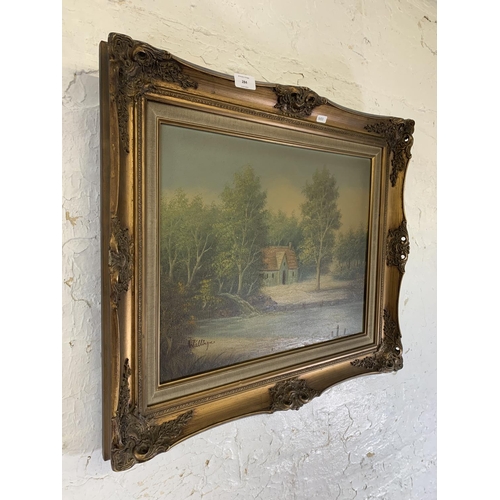 284 - A mid 20th century gilt framed oil on canvas of a riverside scene signed lower left - approx. 58cm h... 