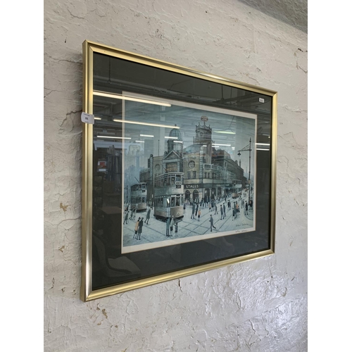 295 - A 20th century framed Arthur Delany pencil signed print of a Manchester street scene with blind mark... 