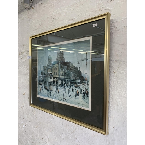 295 - A 20th century framed Arthur Delany pencil signed print of a Manchester street scene with blind mark... 