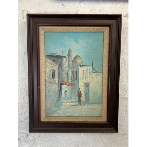 300 - Three mid 20th century Middle Eastern street scene framed paintings - largest approx. 70cm high x 50... 