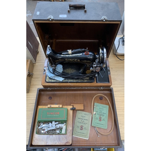 929 - A cased 1940 Singer 99k electric sewing machine with knee bar, boxed attachments and instruction man... 