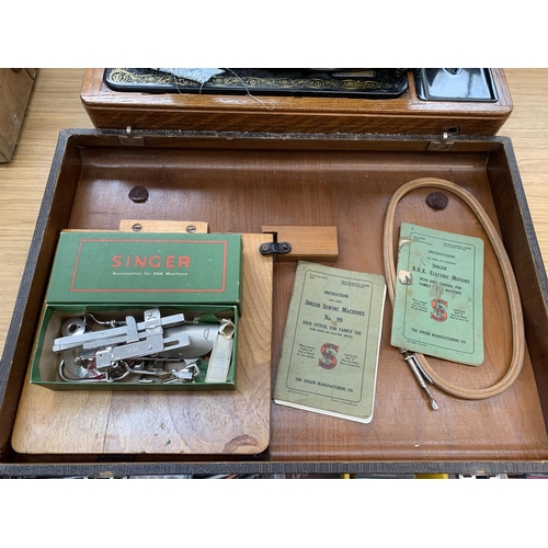 929 - A cased 1940 Singer 99k electric sewing machine with knee bar, boxed attachments and instruction man... 