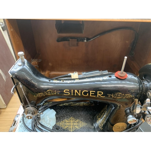 929 - A cased 1940 Singer 99k electric sewing machine with knee bar, boxed attachments and instruction man... 