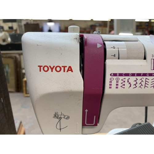 930 - A Toyota SP20 Series ECO34A electric sewing machine with foot pedal