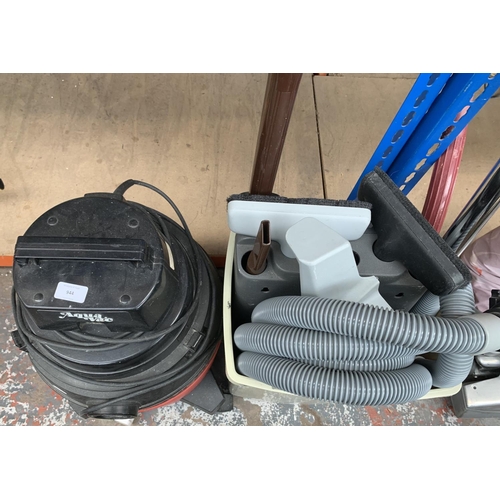 944 - An Aquavac Super 40 wet and dry vacuum cleaner with attachments