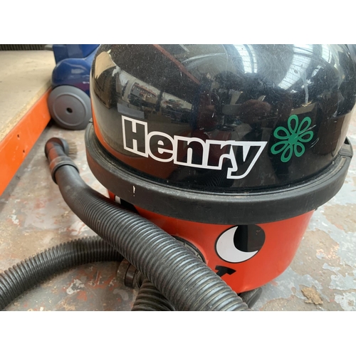 953 - A Numatic Henry cylinder vacuum cleaner with attachments