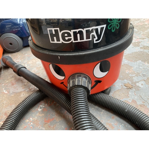 953 - A Numatic Henry cylinder vacuum cleaner with attachments