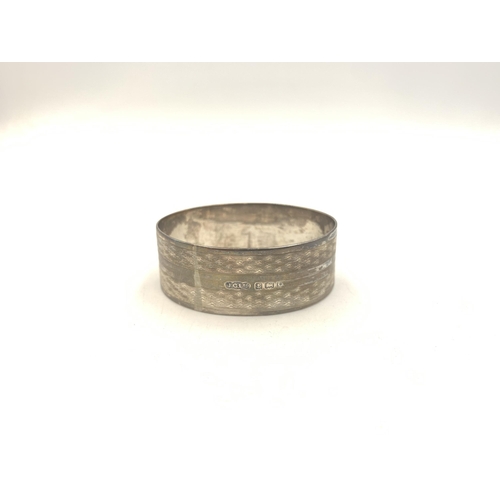 2134 - Three pieces of hallmarked silver, one Birmingham napkin ring, one Victorian William Aitken Chester ... 