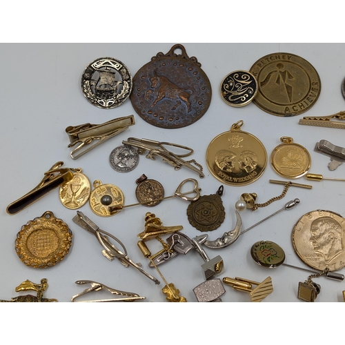 2145 - A collection of various military cufflinks, necklace pendants, coins and tie clips