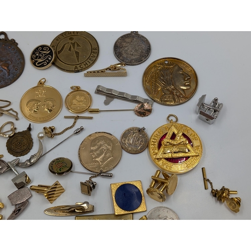 2145 - A collection of various military cufflinks, necklace pendants, coins and tie clips