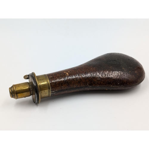 2178 - A 19th century brown leather and brass gun powder flask - approx. 20cm long