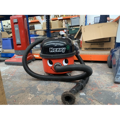 953 - A Numatic Henry cylinder vacuum cleaner with attachments