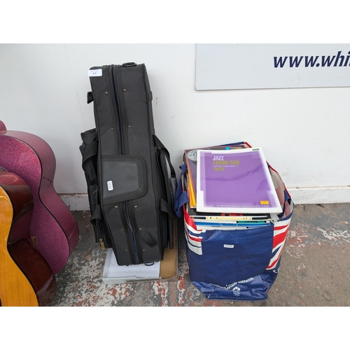 919 - Two items, one P. Mauriat contoured saxophone gig bag and one bag containing a large collection of s... 