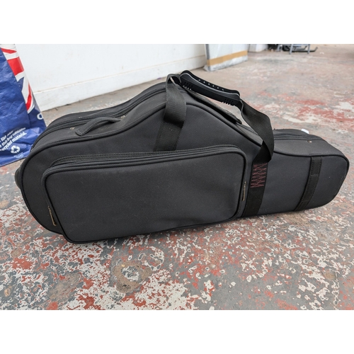 919 - Two items, one P. Mauriat contoured saxophone gig bag and one bag containing a large collection of s... 