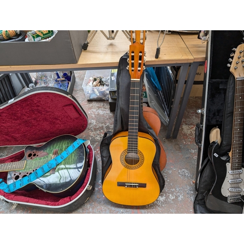 921 - Three nylon strung classical guitars, one cased unbranded child's, one Herald HL34 child's and one T... 