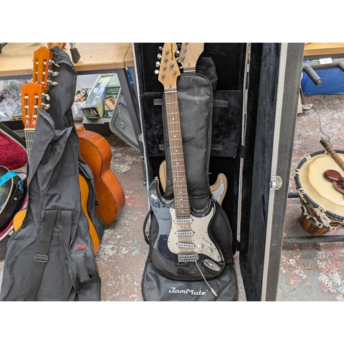 922 - Two Stratocaster style SSS electric guitars, one soft cased JamMate and one Stagg hard cased unbrand... 