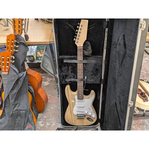 922 - Two Stratocaster style SSS electric guitars, one soft cased JamMate and one Stagg hard cased unbrand... 