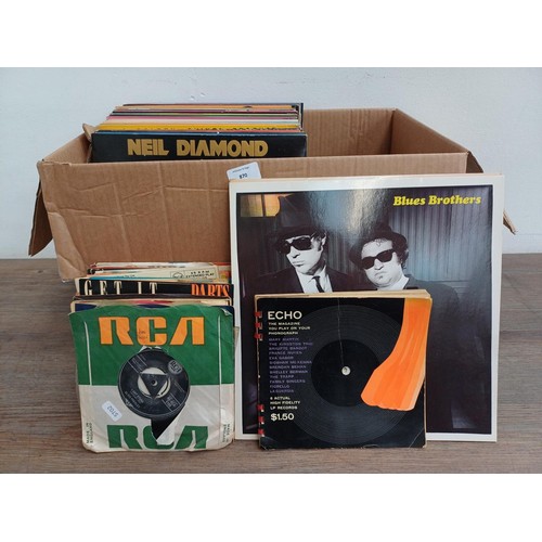 870 - A box containing vinyl records; 7