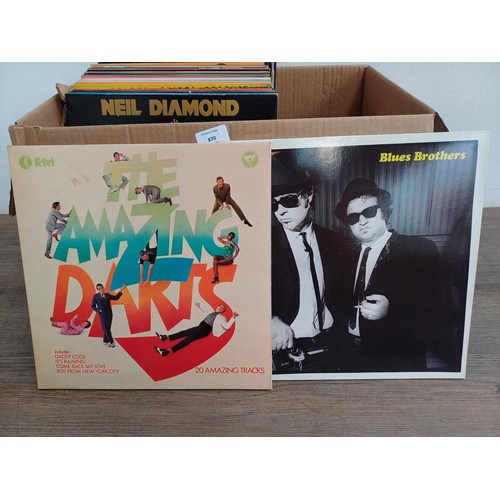 870 - A box containing vinyl records; 7