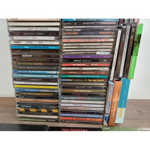 872 - A box containing a collection of CD albums and singles to include Arctic Monkeys, Foo fighters, Haim... 