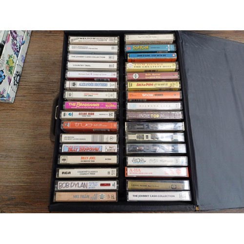 874 - A large collection of compact cassettes to include Chuck Berry, Glen Campbell, Tom Jones, Roy Orbiso... 