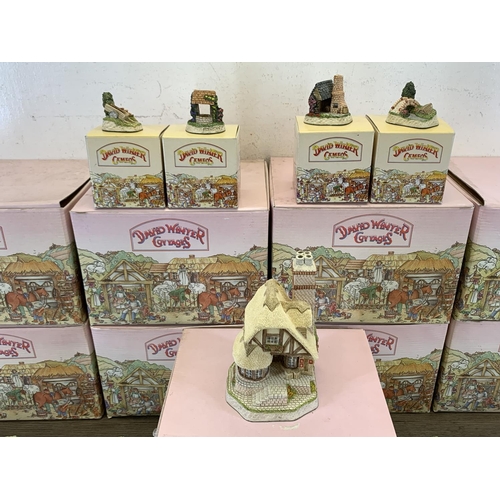 524 - A large collection of boxed David Winter ceramic and hand painted cottage ornaments to include Drove... 