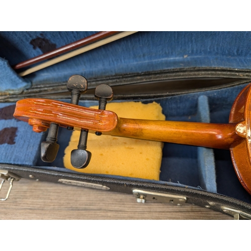 915 - A cased Skylark MV:008 child's student violin with bow and chin rest