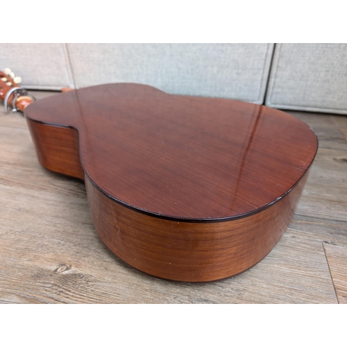 916 - A vintage Antoria 238 nylon strung classical guitar with capo