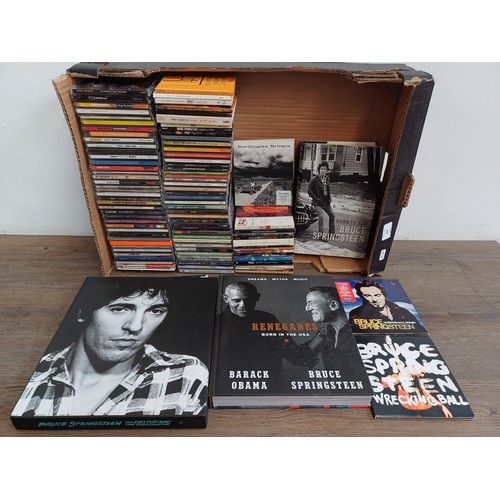 909 - A collection of CDs and books to include Bruce Springsteen 'The Ties That Bind: The River Collection... 