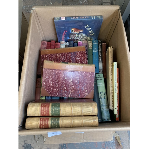 1027 - Three boxes containing books to include authors such as Anthony Sampson, Rudyard Kipling, H. E. Bate... 