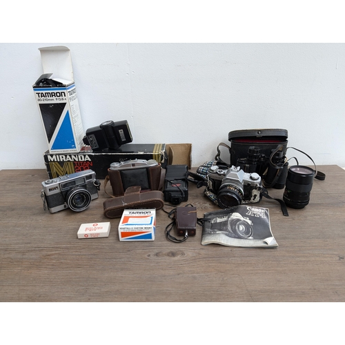 606 - A collection of cameras and accessories to include Fujica Auto-M 35mm camera, Canon AT-1 35mm SLR ca... 