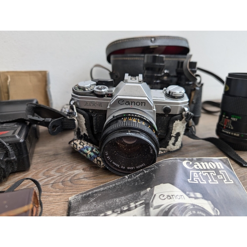 606 - A collection of cameras and accessories to include Fujica Auto-M 35mm camera, Canon AT-1 35mm SLR ca... 