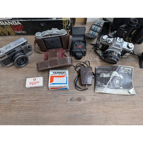 606 - A collection of cameras and accessories to include Fujica Auto-M 35mm camera, Canon AT-1 35mm SLR ca... 