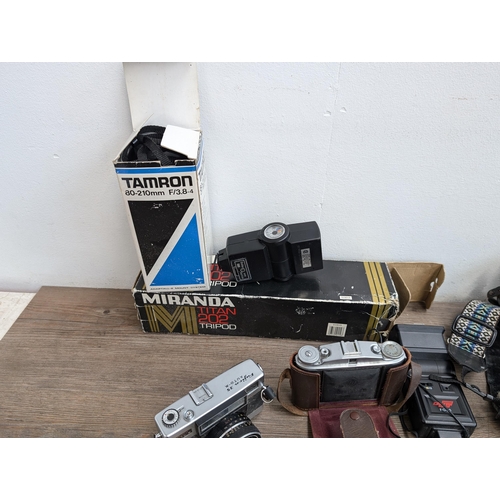 606 - A collection of cameras and accessories to include Fujica Auto-M 35mm camera, Canon AT-1 35mm SLR ca... 