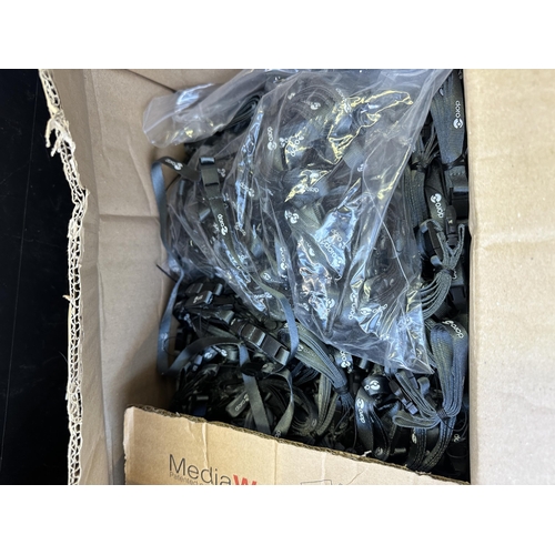 990 - Two boxes containing a large quantity of Doro phone lanyards and landline phone base stations