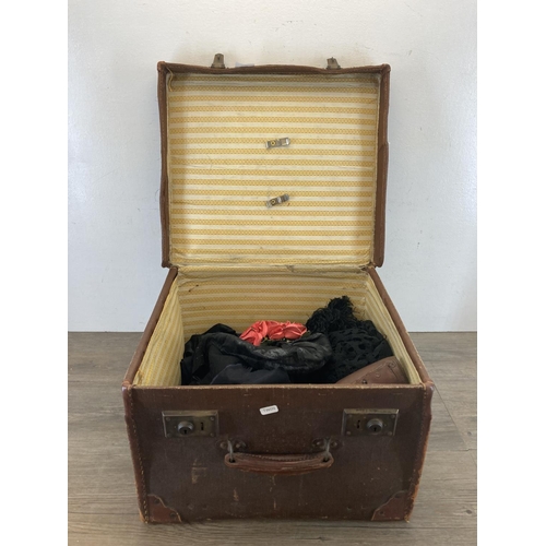 2122 - An early 20th century brown fibreboard case containing a collection of Victorian and later clothing ... 