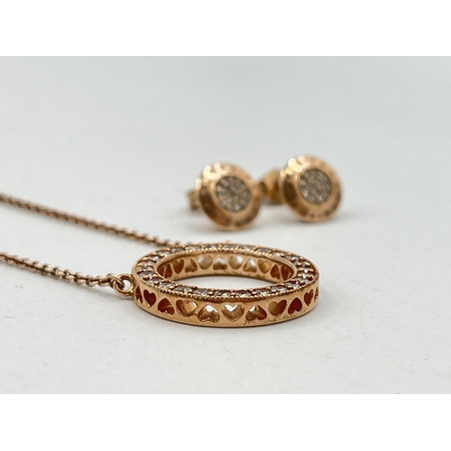 2007 - A boxed Pandora .925 silver and rose gold plated circular CZ pendant necklace and earring set - appr... 