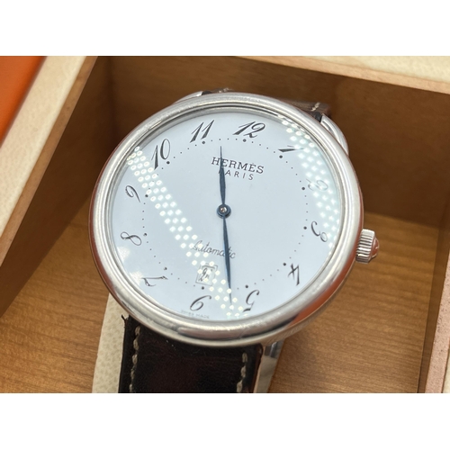 A boxed Hermès Arceau stainless steel automatic men's wristwatch with instruction manual, international guarantee booklet and spare strap - ref no. AR4.810