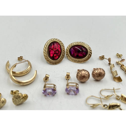 2022 - A collection of 9ct and yellow metal earrings to include 9ct gold pink gemstone earrings, yellow met... 