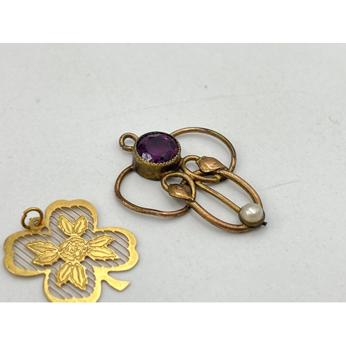 2028 - Two unmarked yellow metal pendants, one Art Nouveau amethyst and seed pearl lavalier and one four le... 